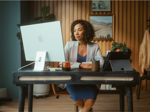 women at computer with headset