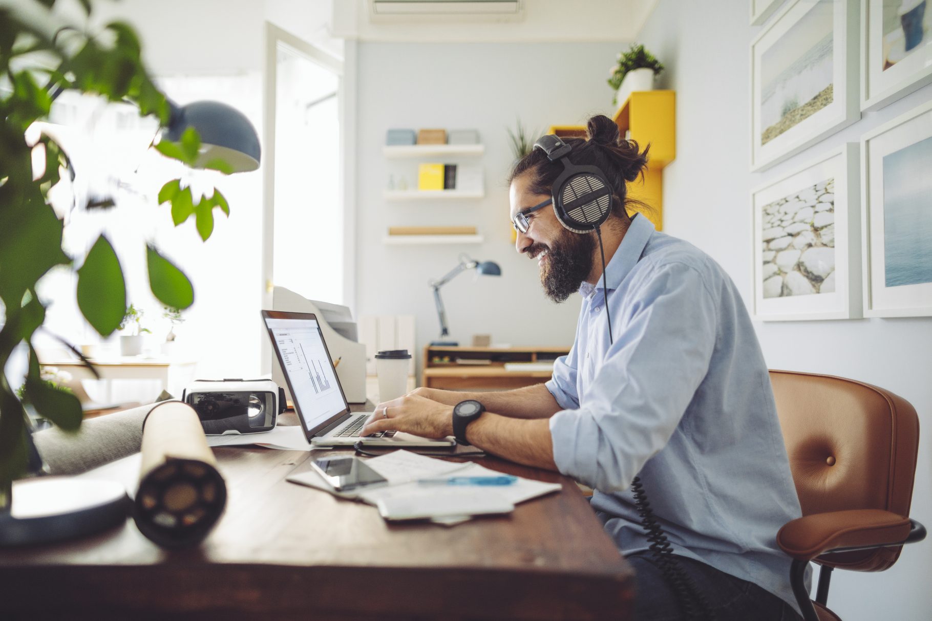 Man on laptop with headphones