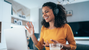 Woman waving on virtual meeting