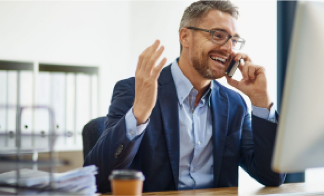 Man talking on cell phone at desk