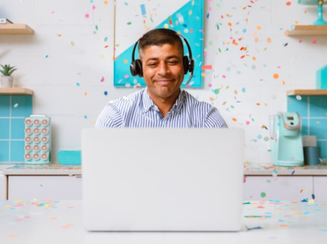 Man celebrating at desk