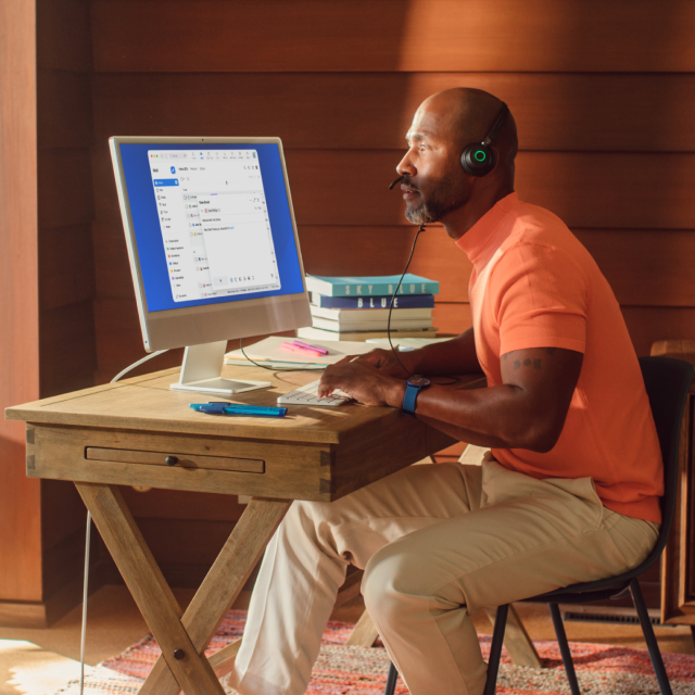 Man at office desk on phone