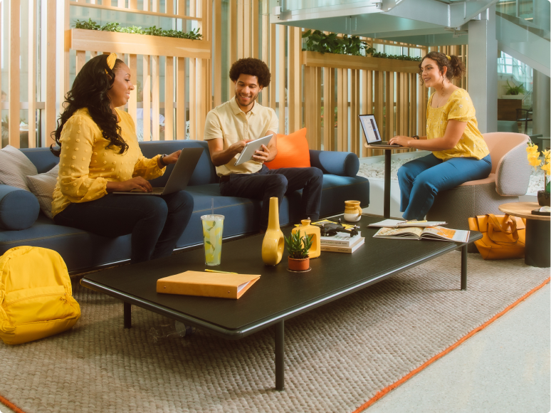 two people sitting on couch with devices