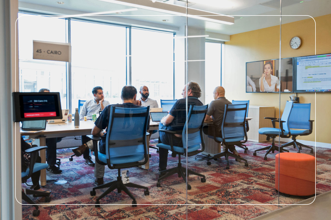 people gathered in a conference room with Zoom Rooms technology