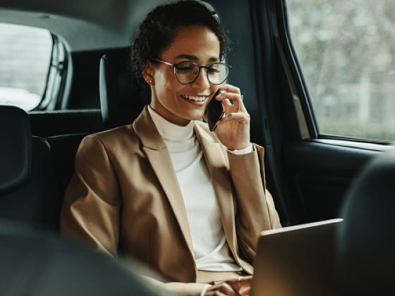 Woman in back of car on phone