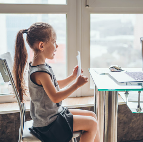 Child displaying paper to Virtual meeting