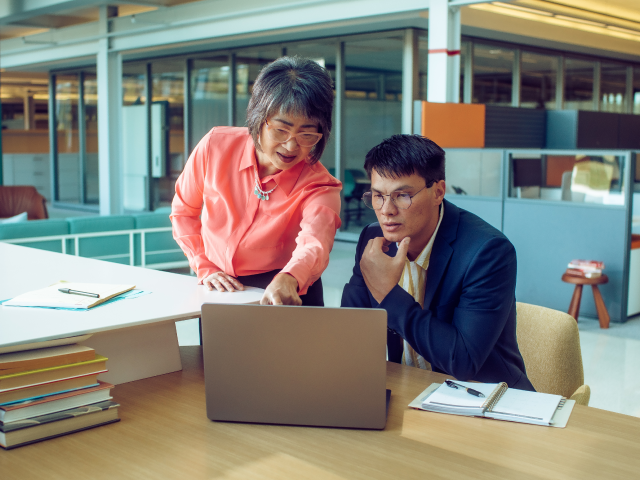 Two people looking at laptop