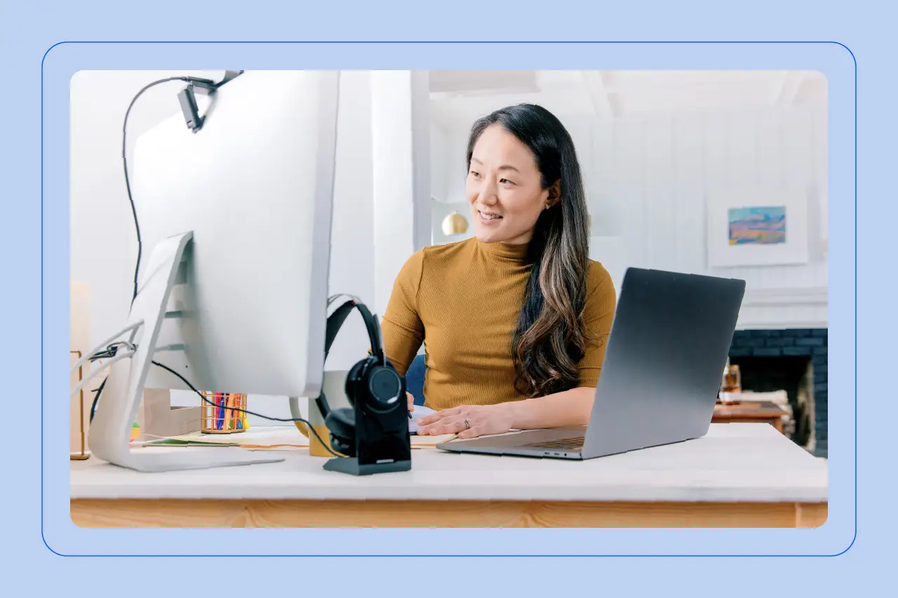 A professional at their desk taking notes while working from home