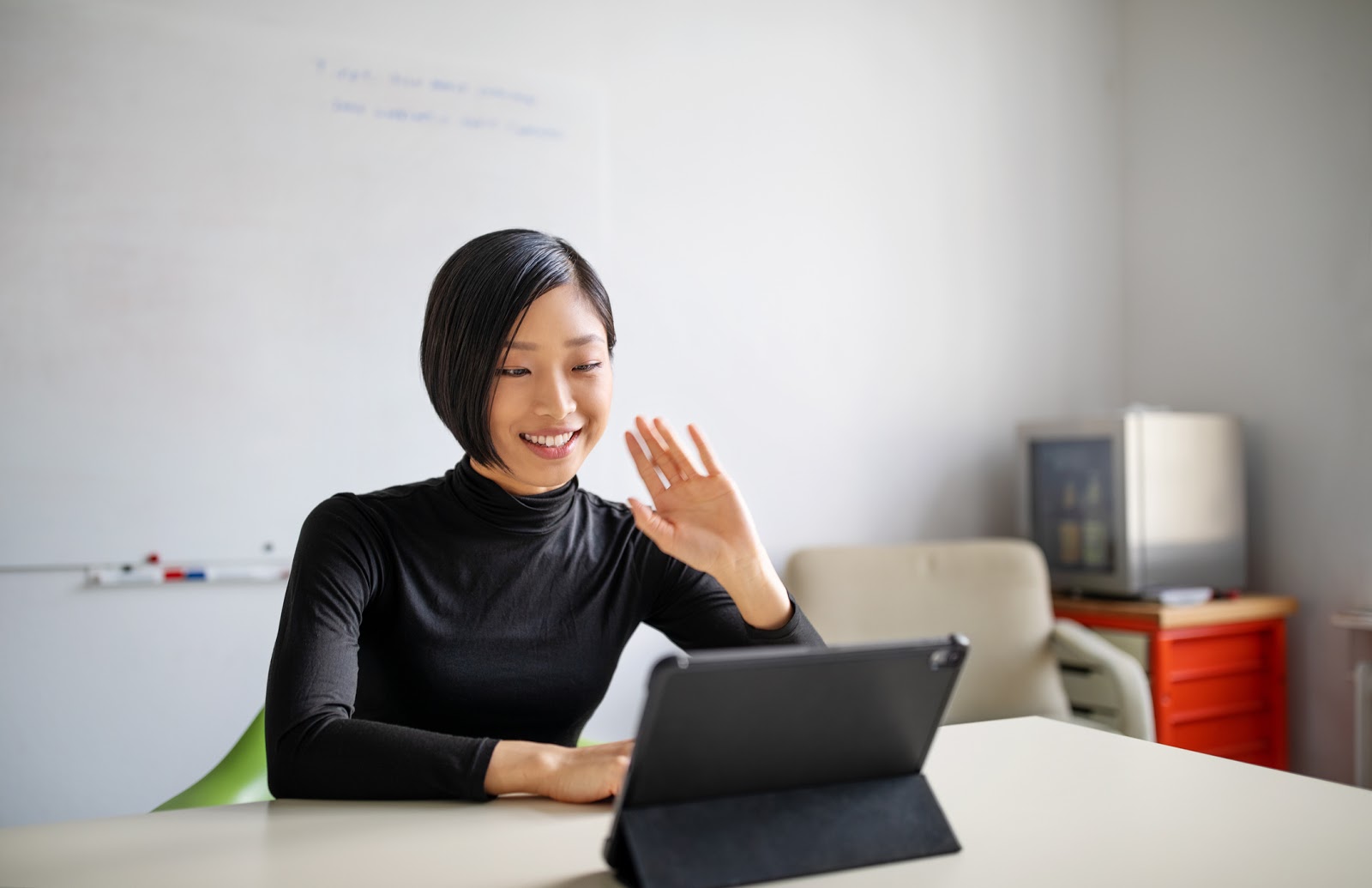 Businesswoman working in office, doing a video call with digital tablet.