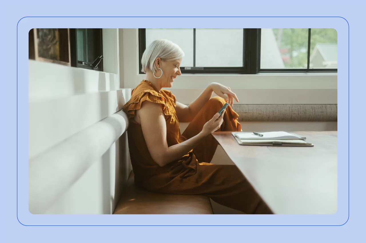 Image of person looking at their phone in a cafe