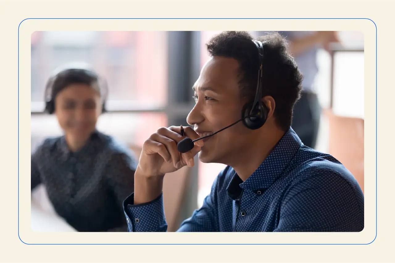 Photo depicting an agent talking on a headset, using a VoIP system to connect with a customer