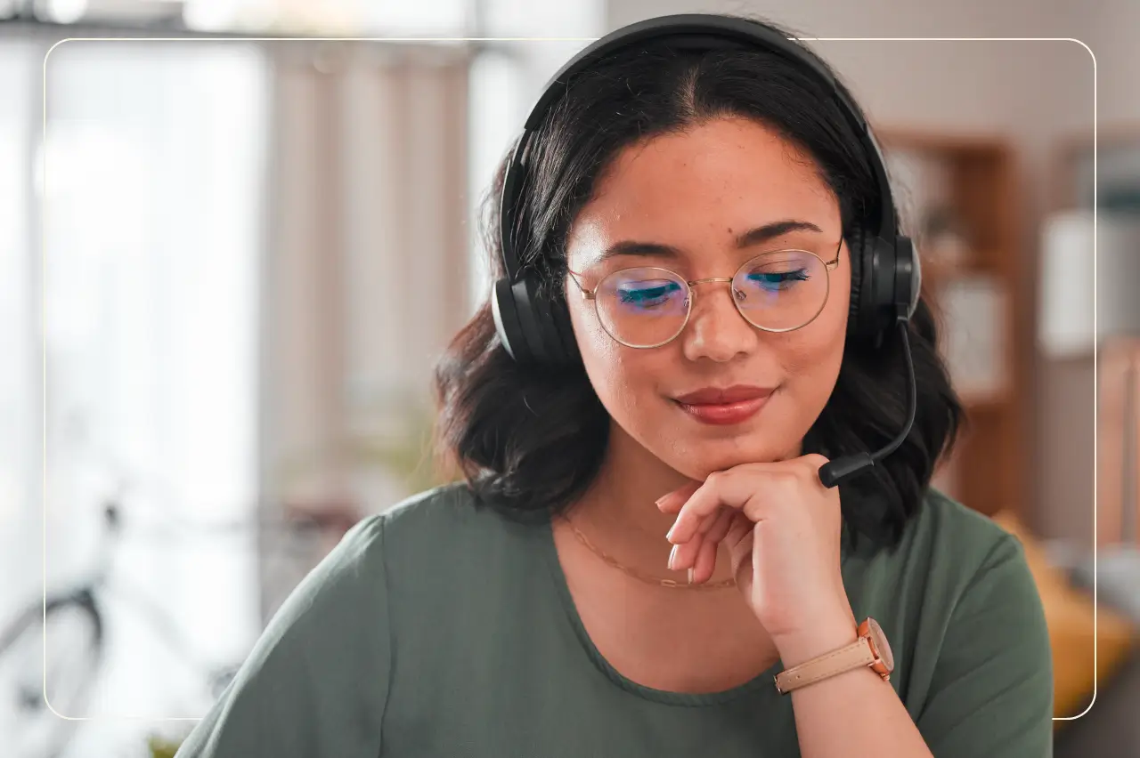 Woman working remotely, wearing glasses and a headset