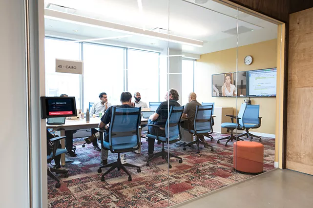A group of team members sitting around a table in the office.